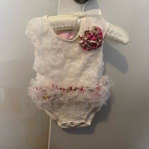New born onsie and 1 year old onsie.